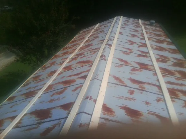 Rusted metal roof panels with new wood purlins before replacement — Storm Damage Roof Repair in Menlo Park by Roofing Brothers