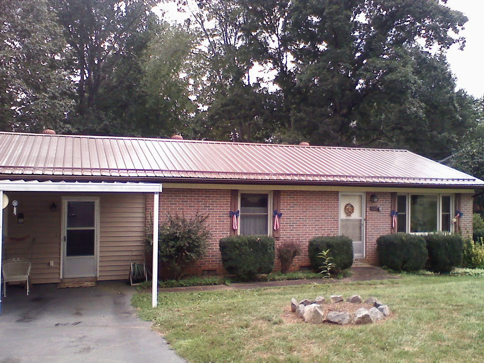 Bronze metal roof and carport on a brick ranch home — Roof Repair work by our crew in Menlo Park