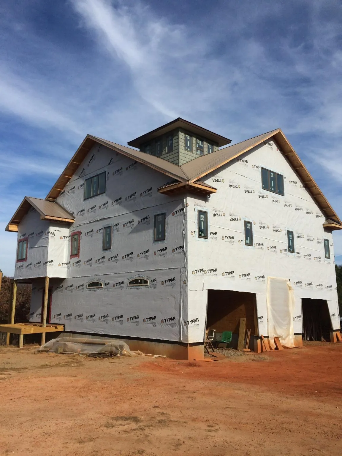 New two story house under construction with a cupola and gabled roofs in Menlo Park